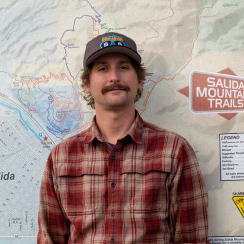 Jon Terbush standing in front of Salida Mountain Trails sign