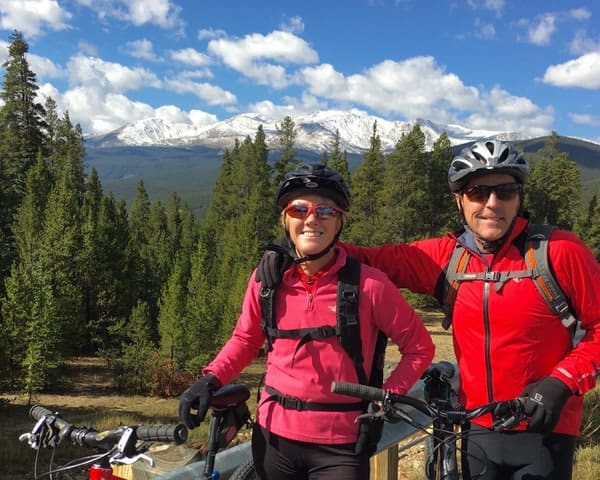 Brenda and Mark Wiard smiling outside with their bikes