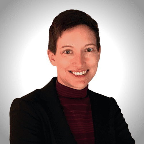 Ruthie Harper, Secretary, smiling wearing black blazer and a white background behind her