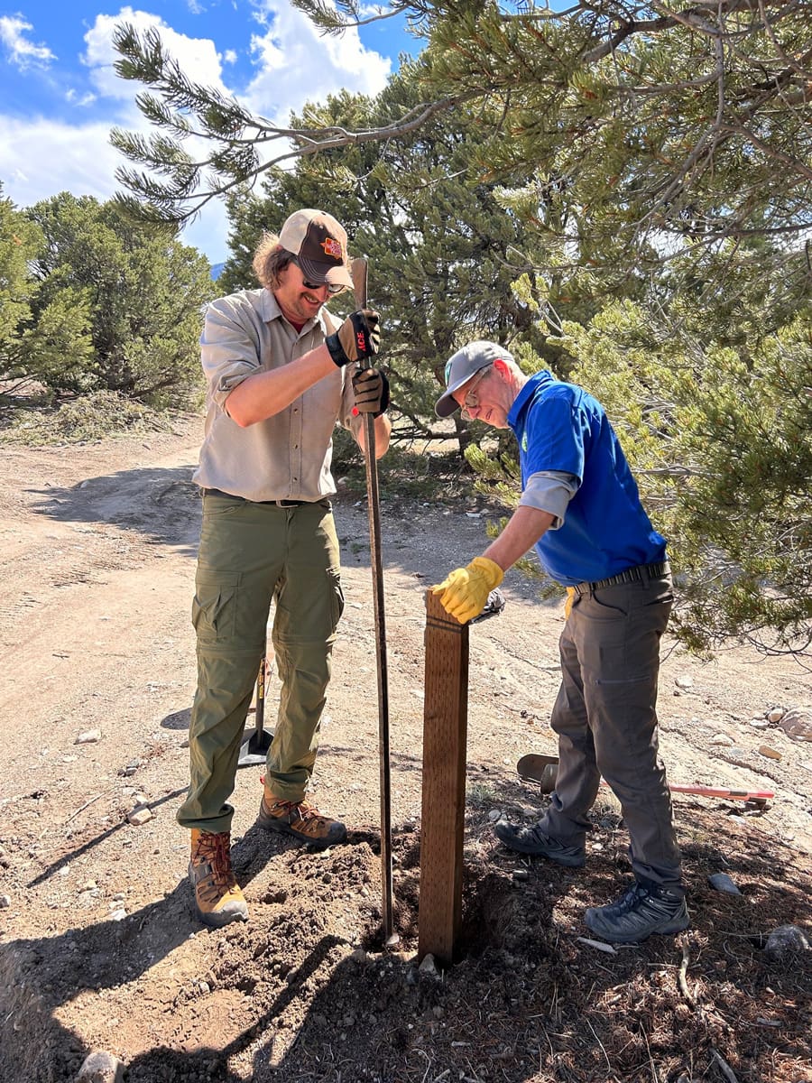 Jon helping install a trail post